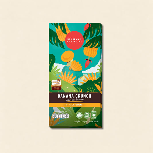 Banana Crunch Milk Chocolate, front packaging on a warm beige background.