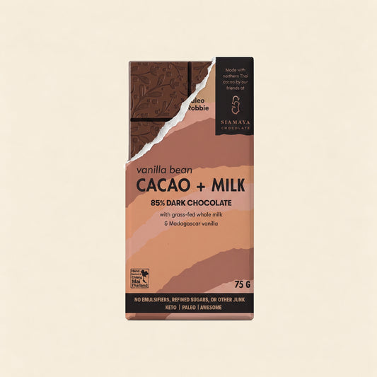 85% Simply Cacao Chocolate Milk & Vanilla, front packaging on a warm beige background.