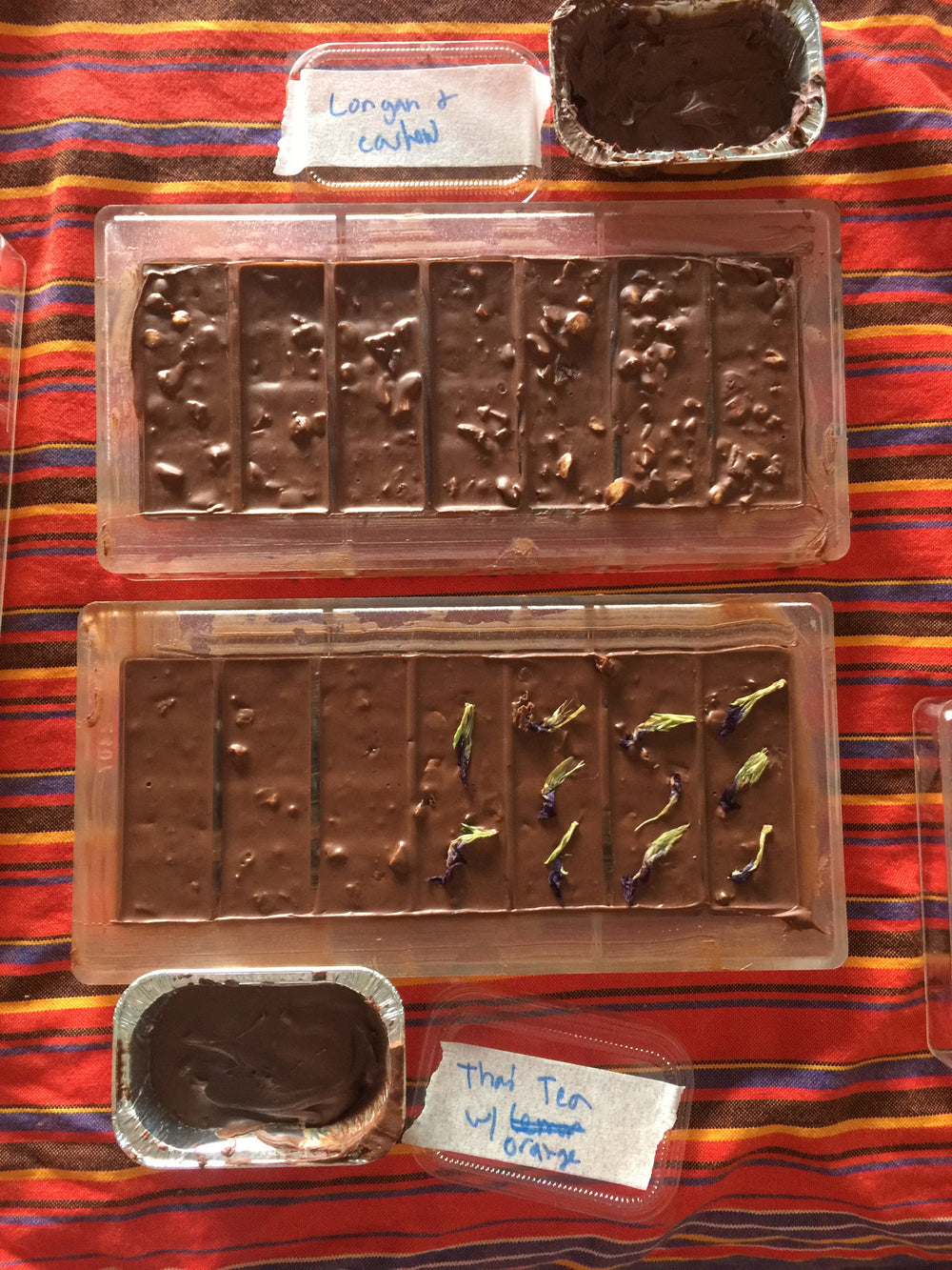 Early chocolate flavor experiments in molds, with handwritten labels.